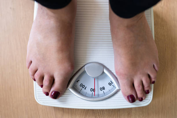 istock Person Standing On Weighing Scale 1398413007
