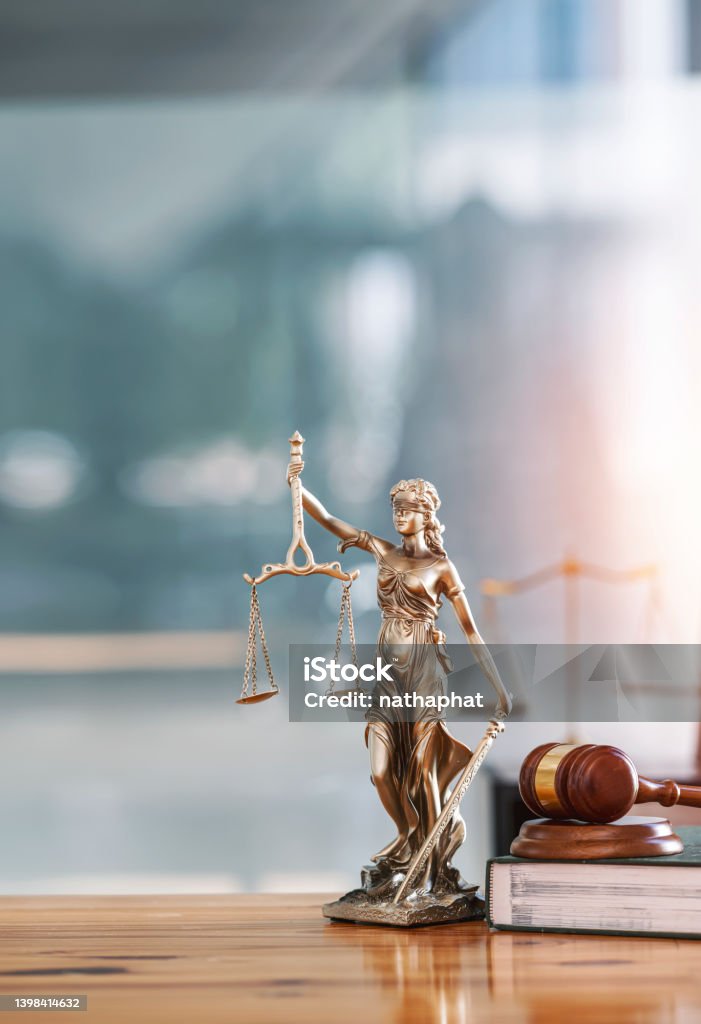 Legal and law concept. Statue of Lady Justice with scales of justice and wooden judge gavel on wooden table. Panoramic image statue of lady justice. Law Stock Photo
