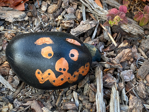 Rock jack-o-lantern in a garden.