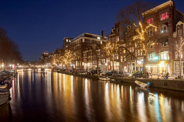 istock Amsterdam canal cityscape at night 1398425101