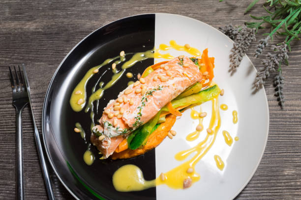 Salmon steak on a plate with Thai vegetables and sweet and sour mango sauce stock photo