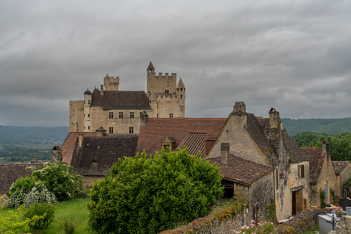 Beynac-et-Cazenac, France - 12 May, 2022: view of the Beynac Castle in the Dordogne Valley under an overcast expressive sky