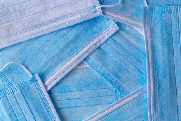 istock Many stacked medical blue masks on background 1398426190