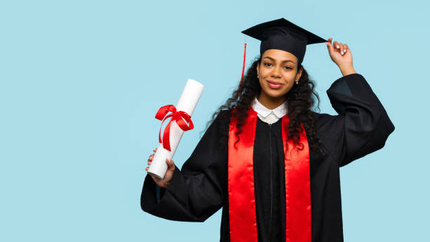 African american woman in graduate dress and mortarboard stock photo