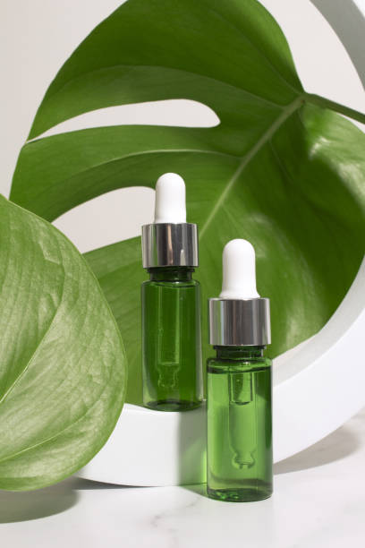 istock Dropper bottle with monstera palm leaf. Aromatic oil container, medical packaging template. Herbal cosmetic concept. 1398430174