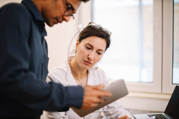 istock colleagues discussing work in the medical office 1398432253