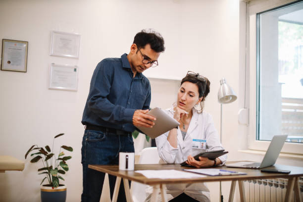 istock colleagues discussing work in the medical office 1398432392