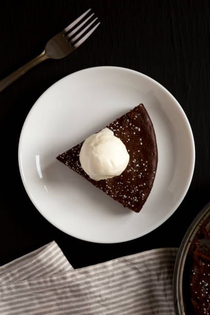 istock Homemade Chocolate Cake with Ice Cream on a black surface, top view. Flat lay, overhead, from above. 1398433436