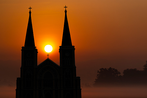 Silhouette of the church at sunrise in the background