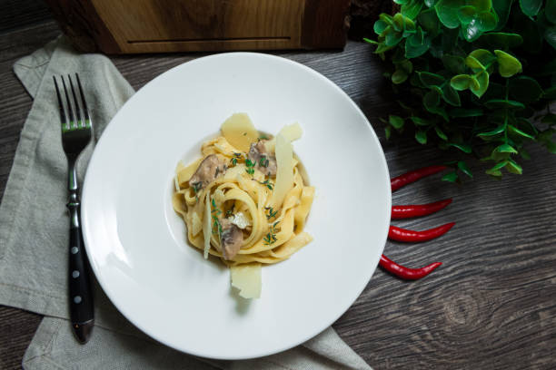 istock Creamy tagliatelle pasta (fettuccini) with mushrooms and parmesan cheese 1398438982