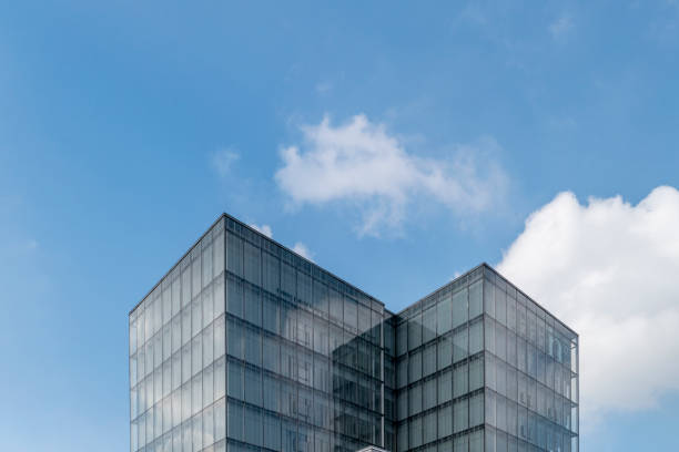 istock Facade of modern building under blue sky and white clouds 1398440233