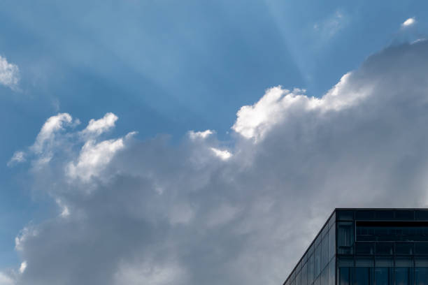 Facade of modern building under blue sky and white clouds