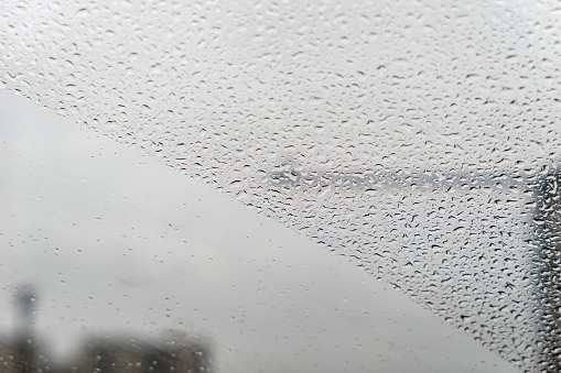 Raindrops on car window in rainy day