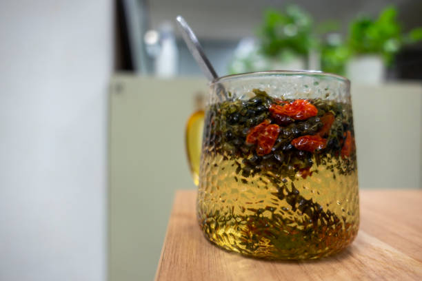 Chinese tea culture, green tea brewed wolfberry in the office Chinese tea culture, green tea brewed wolfberry in the office wolfberry stock pictures, royalty-free photos & images