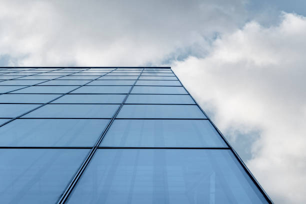 istock Facade of modern building under blue sky and white clouds 1398440726