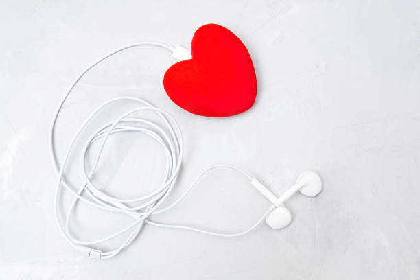 istock Red heart with earphones on gray background 1398442714