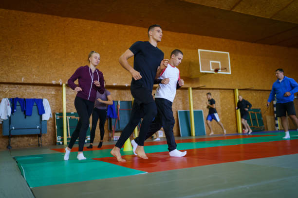 istock Young sports team running indoors 1398443693
