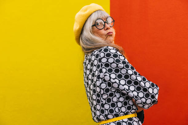 istock Funny elderly woman pouting her lips against a colourful background 1398446962