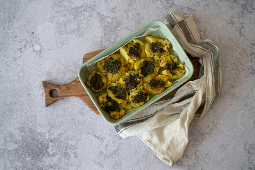 Baked smashed potato with pesto dressing