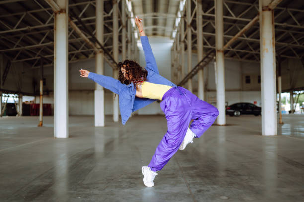 istock Young  woman - dancer dancing  in the underpass. 1398451010