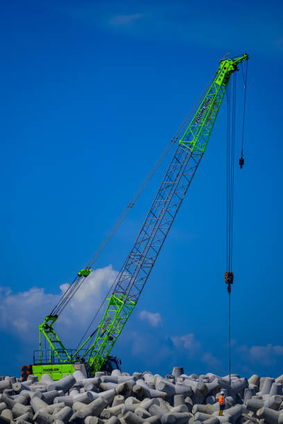 Yogyakarat, Indonesia - Mei 16, 2022: Tetrapod installation process by crane truck at Congot beach, Yogyakarta international airport