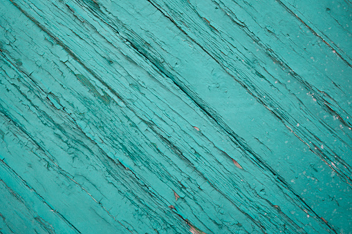 old aqua blue painted diagonal wooden planks . Rustic turquoise blue wooden planks diagonally. Copy space