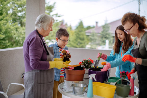 istock Multi generation family potting flower 1398454691
