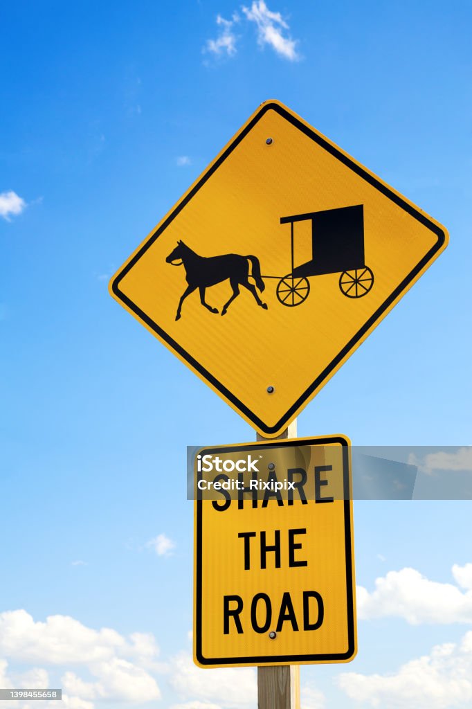 Amish road sign A road sign warning drivers to share the road with the local Amish horse and buggies. Amish Stock Photo