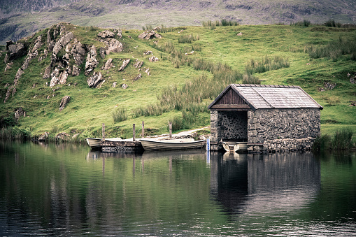 An old stone boathouse on a lake in Snowdonia, North Wales. Nostalgic effect with intentional vignetting.