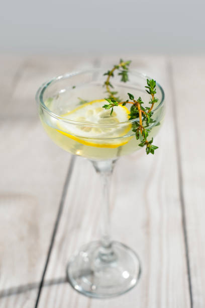istock Holiday gin cocktail with lemon and thyme. 1398457941