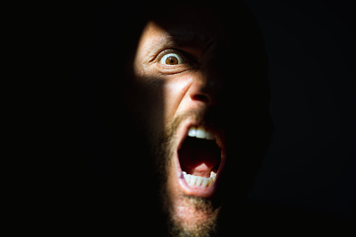 Scared woman on dark background