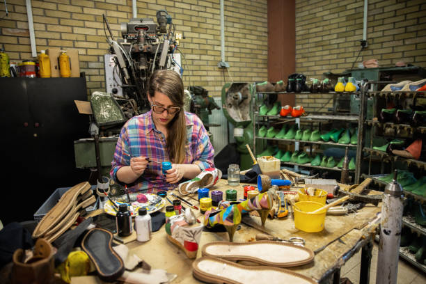 istock Female artist paint the high heels, while working at the workshop 1398460318