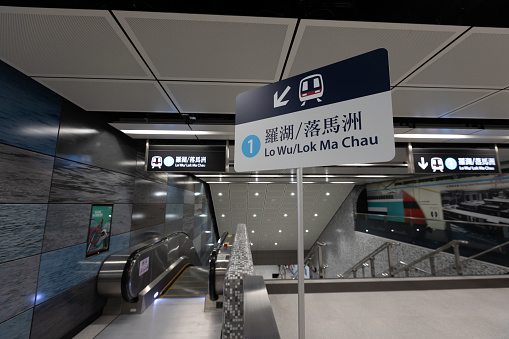 Hong Kong - May 20, 2022 : Lo Wu/ Lok Ma Chau signs at the MTR Exhibition Centre Station in Hong Kong. The cross-harbour extension of the East Rail line fully opened on May 15.