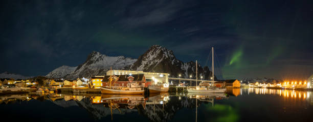 Svolvaer by dusk in Vagan Nordland Lofoten arcipelago  North of Norway . Svolvaer with the Northern lights  in Austvagoya island Vagan Nordland Lofoten archipelago  North of Norway on March 12, 2022. View from the island of Lamholmen, in the middle of Svolvær Harbour.  Panorama. harbor of svolvaer in winter lofoten islands norway stock pictures, royalty-free photos & images