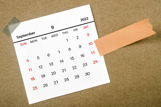istock September 2022 calendar with blank adhesive note paper on brown background. 1398477641