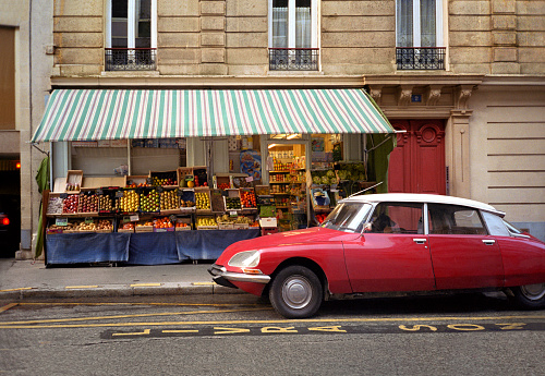 A red Citroën DS parked in front of an alimentation générale, just north of place de la République in the 10th arrondissement.