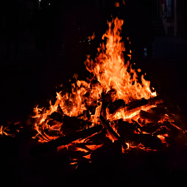 istock Fire flames on black background, Blaze fire flame texture background, Beautifully, the fire is burning, Fire flames with wood and cow dung bonfire 1398480179