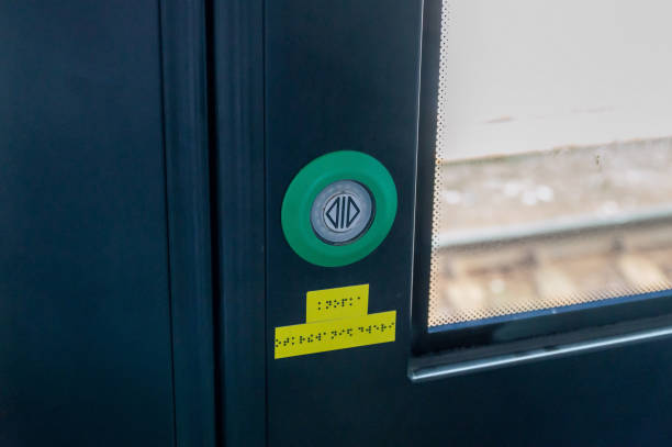istock door opening button on a commuter train. text in Russian braille door opening button 1398480830