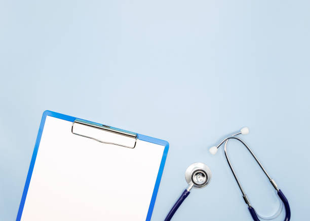 istock Flat lay of stethoscope and writing pad paper clip board on light blue background with copy space, healthcare and medical concept, top view photo. 1398483428