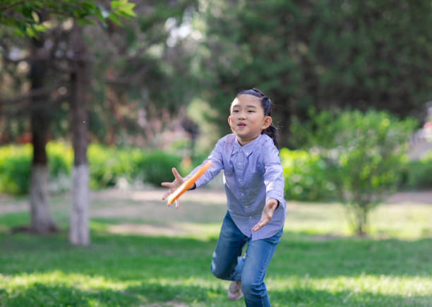 istock Little Girl Playing Frisbee 1398483876