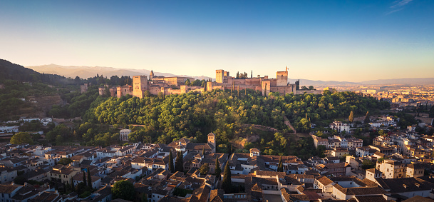 A view of an ancient palace at sunset at the Alhambra in Spain. A perfect mirrored reflection.