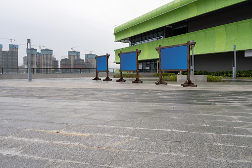 Stone plazas and modern urban buildings without people in the rain