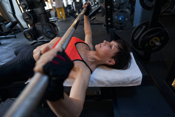 istock Professional female bodybuilder performing upper-body weight-training exercise 1398486405