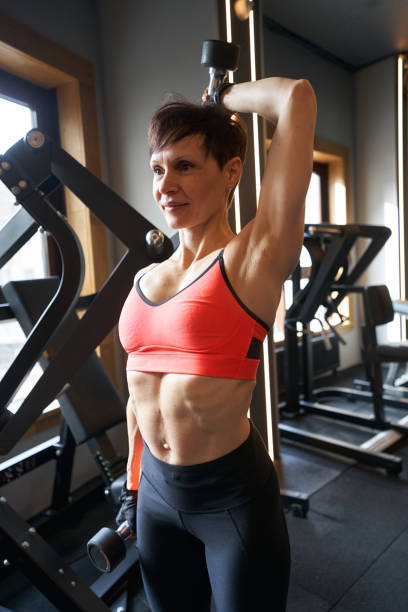 istock Woman performing arm exercise with hand weights 1398486436