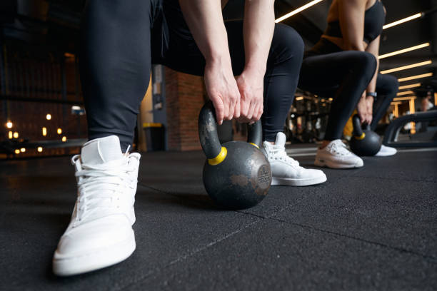 istock Professional bodybuilders doing weight-lifting workout at gym 1398486470