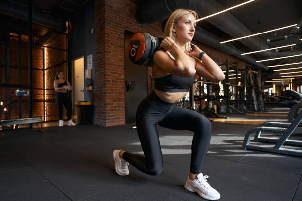 istock Sporty lady doing strength training at gym 1398486477