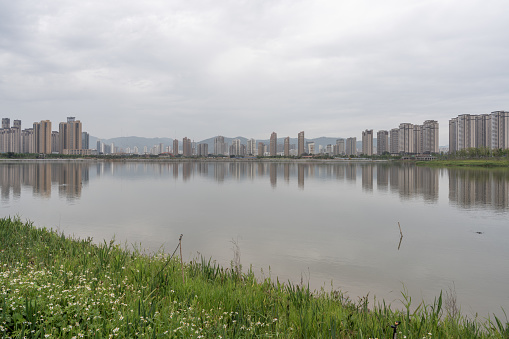 The lake in the rain reflected the skyline of the city