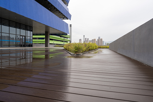 Empty wooden aisles and urban buildings in the rain