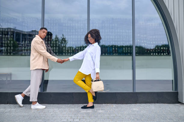 istock Guy and girl opposite each other holding hands 1398489200