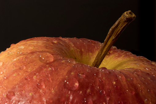 Macro photo of an apple  with water drops sprinkled on it